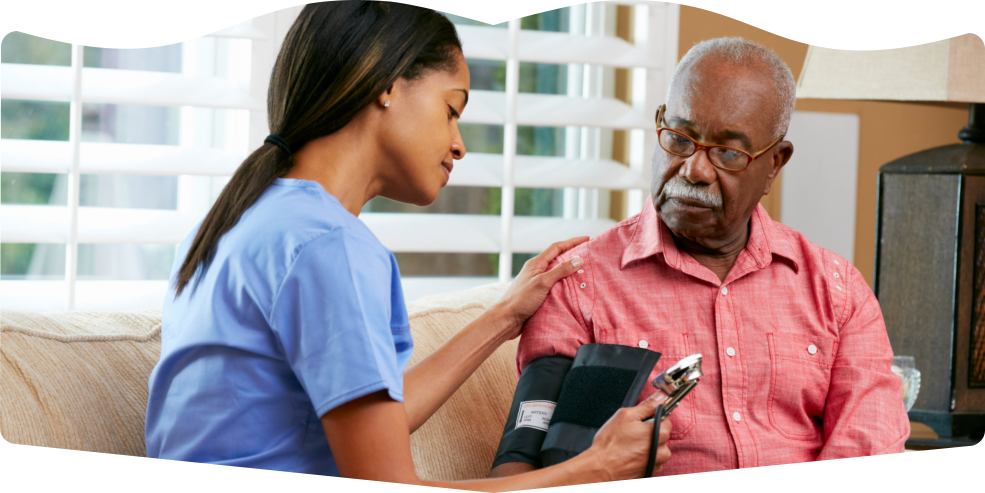 caregiver monitoring the blood pressure of an male senior